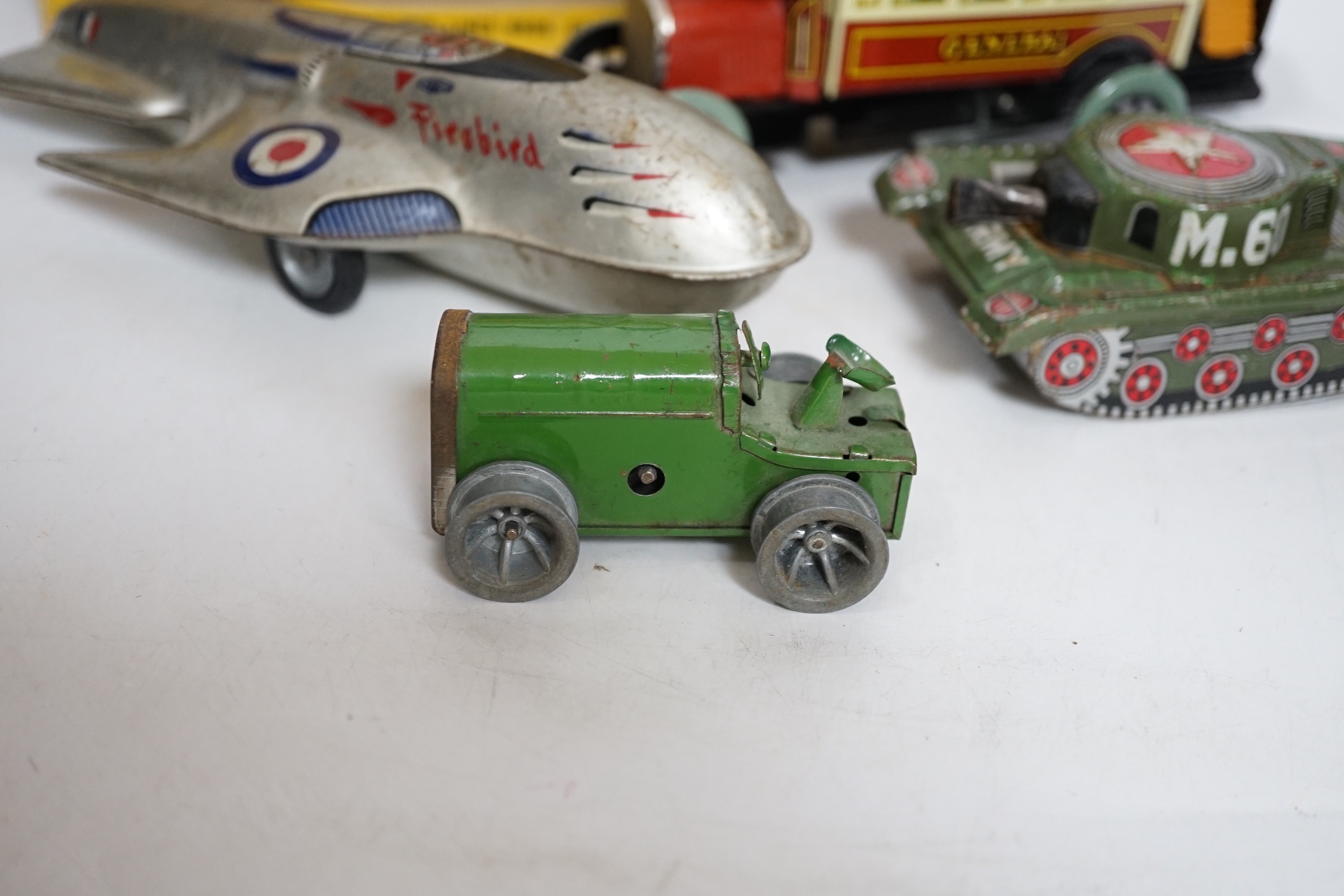 A collection of tinplate toys including cars, a fire engine, a Firebird jet plane, a Tri-ang lifeboat, an Tri-ang Minic tractor, etc. (11), together with a box of boardgames including Vintage Gibson and others; Bandit Ch